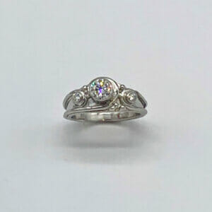 Platinum Lazare diamond ring has one flat side to sit against a plain band