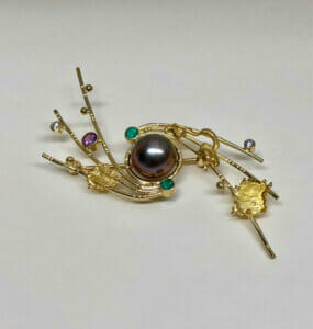 South Sea pearl brooch has pink sapphire, emeralds and diamonds