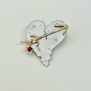 Gold heart broach with a ruby accent