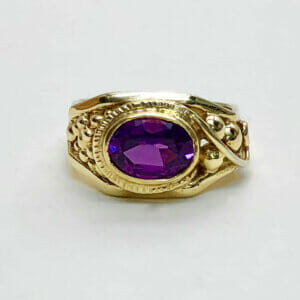 Yellow gold ring with big purple sapphire