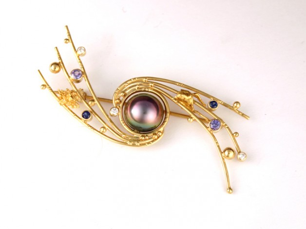 Order this 18k and 22k gold pin with black South Sea pearl, purple sapphires and diamonds from Spirer Jewelry Boston Cambridge