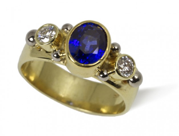 Daniel Spirer Jewelers of Boston presents this ring of 18k yellow gold with 18k white gold accents, blue sapphire and diamonds