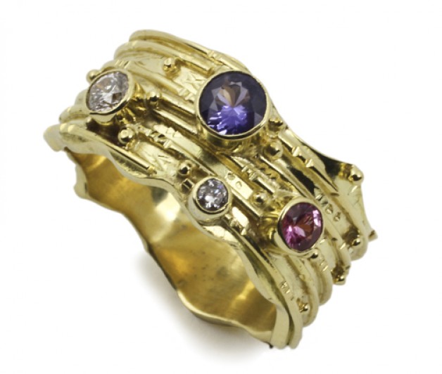 Boston jeweler Daniel R. Spirer handcrafted this 18k yellow gold ring with purple and pink sapphires and diamonds