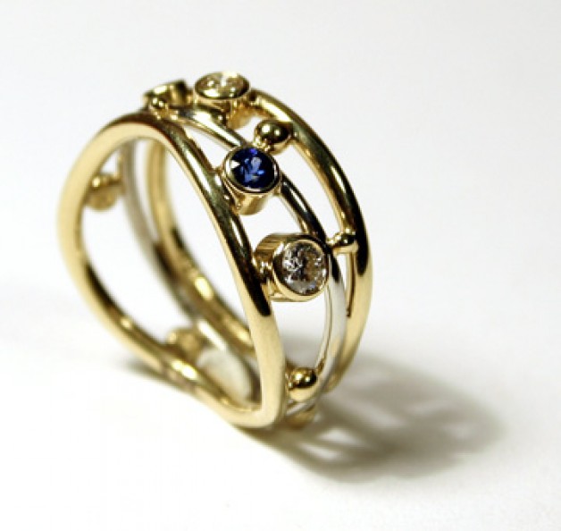 Cambridge, Massachusetts jeweler Daniel R. Spirer created this ring of 18k and 950 platinum with diamonds and sapphires