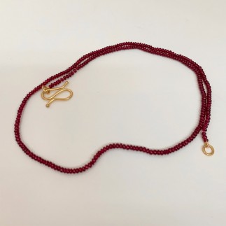 Ruby bead necklace has gold clasp