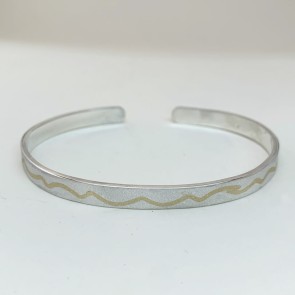 silver love bangle bracelet has gold river run thru it