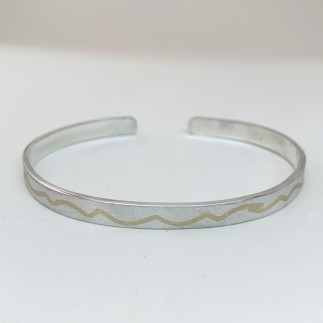 silver love bangle bracelet has gold river run thru it