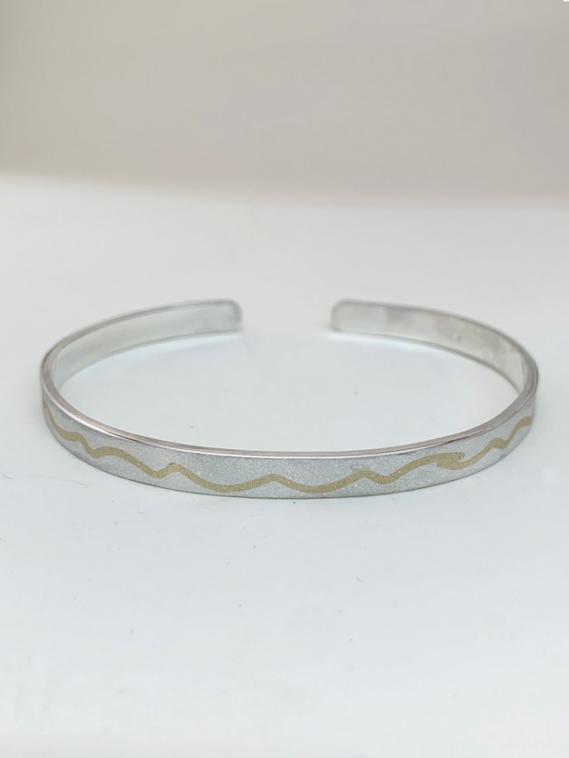 silver love bangle bracelet has gold river run thru it