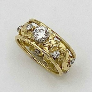 18k yellow gold Elizabethan design band with platinum settings for all stones with a .52 ct., VVS1 clarity, F color Lazare Diamond with eight .o3 ct. E color, VS clarity diamonds around the band. The ring is 8 mm in width.