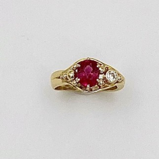 Fine rubies are one of the rarest gem materials available today! This 1.37 ct. ruby (H) is flanked by a bezel set  .10 ct., E color, VS clarity diamond.
