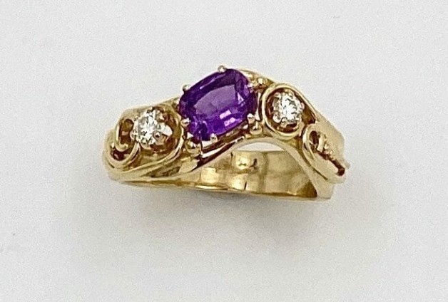 18k yellow gold ring with a 1.22 ct. cushion cut natural color purple sapphire flanked by .15 ct. ideal cut, 