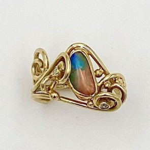 18k yellow gold ring with a 22k gold bezel set Australian boulder opal and two .03 ct., E color, VS clarity diamonds.