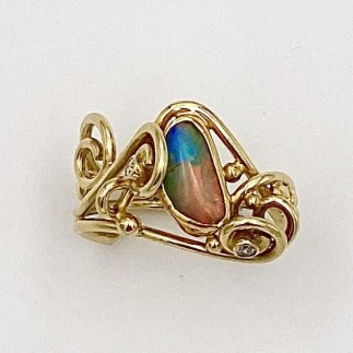 18k yellow gold ring with a 22k gold bezel set Australian boulder opal and two .03 ct., E color, VS clarity diamonds.