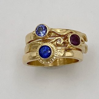18k yellow gold stacking rings with blue, purple and dark pink sapphires, TW .55 ct. and two .01 ct., E color, VS clarity diamonds. Wear these rings in any order you like