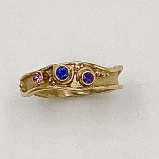 18k yellow gold ring with .15 ct. t.w. blue, purple and pink sapphires (H). This narrow 18k gold ring is easy to stack or just wear on its own.