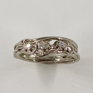 950 platinum band with 3 diamonds, TW .14ct. in one of Daniel's classic wirey settings.