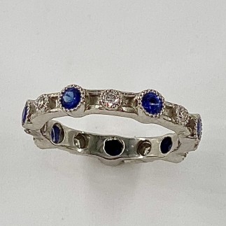 950 platinum eternity style band with 7 blue sapphires (H) with a TW .75 cts. and 7 E color, VS clarity diamonds TW .14 ct.