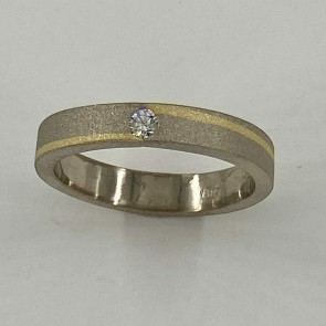 18k palladium white gold with 18k yellow gold inlay with .10ct. E color, VS clarity diamond in the center.