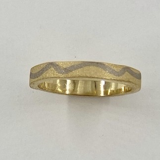 3mm wide 18k yellow gold ring with an 18k palladium white gold river and a sand blasted finish