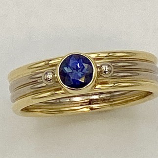 18k yellow gold and 18k palladium white gold ring with .45ct purple sapphire (N)