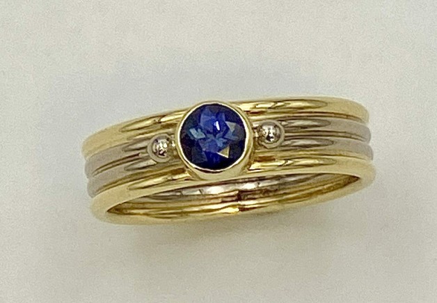 18k yellow gold and 18k palladium white gold ring with .45ct purple sapphire (N)