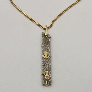 18k yellow gold and meteorite pendant with 22k yellow gold aliens and .03 ct, E color, VS clarity diamond. Chain is priced separately.