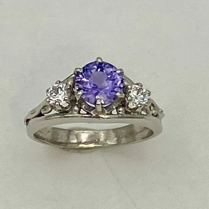 950 platinum ring with a 1.22ct violet/blue color shift, unheated Sri Lankan sapphire flanked by a .15ct diamond on each side E color, VS clarity