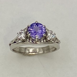 950 platinum ring with a 1.22ct violet/blue color shift, unheated Sri Lankan sapphire flanked by a .15ct diamond on each side E color, VS clarity