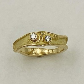 Petite 18k yellow gold with a .06 ct. and .03 ct. "E" color, VS clarity diamond.