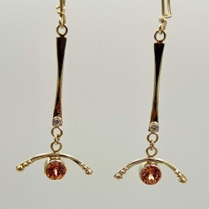 18k yellow gold and natural color orange garnet (t.w. 2.39 ct.) pendant style earrings with a .03 ct. E color VS clarity diamond on each. 2 ¼” long.