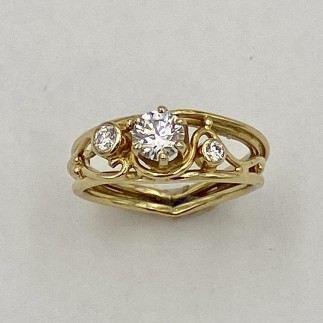 A play on one of my favorite rings. 18k yellow gold with a .48 ct., E color, VS1 clarity ideal cut diamond in the center and flanked by a .08 ct. and .03 ct., "E" color, VS clarity diamond.
