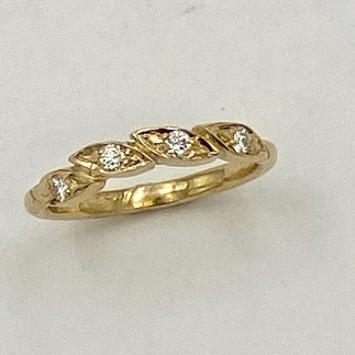 18k yellow gold leaf ring with a .o3 ct., E color, VS clarity diamond in each leaf.