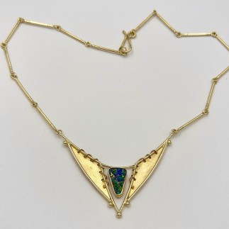 18k and 22k yellow gold handmade necklace with fine Australian boulder opal. The background, wrapped wire and bezel on the pendant are all 22k yellow gold. Measures 17 inches but length can be altered.