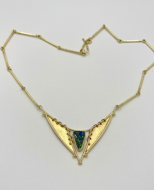18k and 22k yellow gold handmade necklace with fine Australian boulder opal. The background, wrapped wire and bezel on the pendant are all 22k yellow gold. Measures 17 inches but length can be altered.