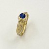 Sandblasted 18k yellow gold ring with 950 platinum accents and a .78ct. fine dark blue sapphire (H) in this unique Daniel Spirer design