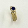 Sandblasted 18k yellow gold ring with 950 platinum accents and a .78ct. fine dark blue sapphire (H) in this unique Daniel Spirer design