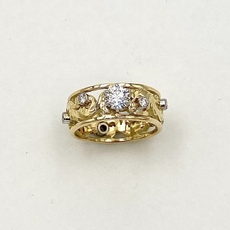 18k yellow gold Elizabethan design ring with a .51 ct., F color, VS1 clarity Lazare Diamond in a six prong platinum setting with eight .03 ct., E color, VS clarity diamonds set in platinum bezels around the ring.