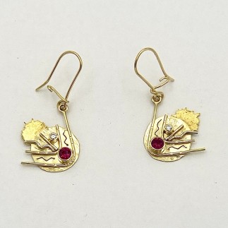 18k yellow gold, 22k gold and platinum comet earrings with .66ct.  (TW) Burmese rubies and .09 ct. (TW) E color, VS clarity diamonds. Measures 1.5 inches long including ear wire.