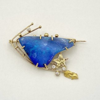 18k and 22k yellow gold comet pin with a boulder opal and four diamonds (TW .18ct.), E color, VS clarity. Opal is a lighter blue than it appears in the picture.