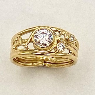 18k yellow gold diamond ring with a .51 ct. E color, VVS1 clarity, ideal cut Lazare Diamond in the center flanked by a .03 ct. and .05 ct E color, VS clarity diamond.