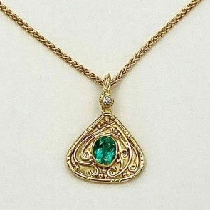 18k yellow gold hand built pendant with a 1.28 ct. Brazilian blue green tourmaline (H) in a 22k bezel setting with a .05 ct. E color, VS clarity diamond. 1 1/8 inches long by 3/4 inch wide. Chain sold separately. Email for chain pricing.