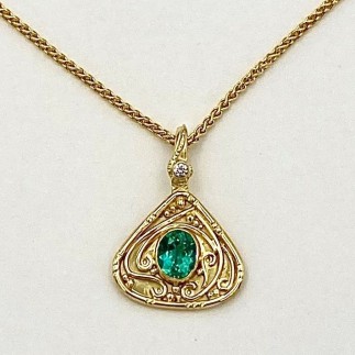 18k yellow gold hand built pendant with a 1.28 ct. Brazilian blue green tourmaline (H) in a 22k bezel setting with a .05 ct. E color, VS clarity diamond. 1 1/8 inches long by 3/4 inch wide. Chain sold separately. Email for chain pricing.