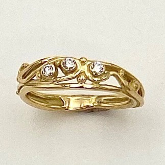 18k yellow gold ring with three diamonds, E color, VS clarity, TW .10 cts. This ring can either be worn as a wedding band that fits up against "The Ring" or it can be worn alone, stacked or with other engagement rings.