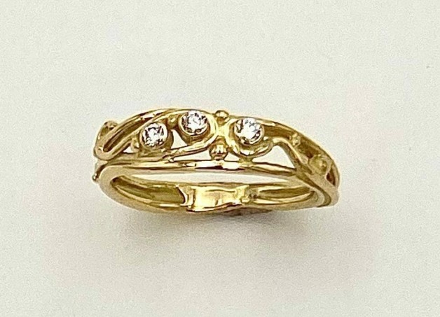18k yellow gold ring with three diamonds, E color, VS clarity, TW .10 cts. This ring can either be worn as a wedding band that fits up against 