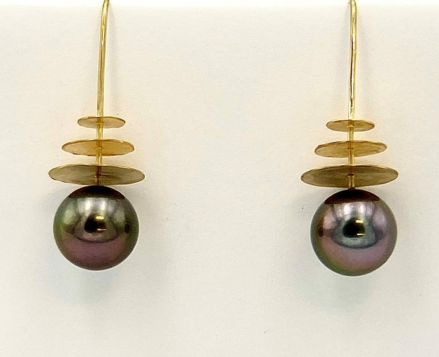 22k and 18k yellow gold earrings with 11.3mm round black South Sea pearls. Earrings have a low polish finish.