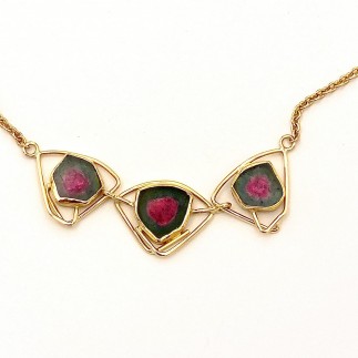 18 and 22 kt yellow gold necklace with three watermelon tourmalines. The necklace measures 17.5 inches long.