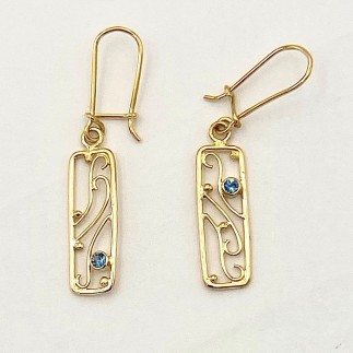 One of a kind 18 k yellow gold earrings with .15ct (TW) teal colored Montana sapphires. Measures 1 3/4 inch long. Lightweight
