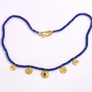 Blue sapphire (H) beads (52 cts. TW) with five 22k gold discs, 1 disc with a .32ct. blue sapphire cabochon. Measure 17 1/4 inches long.