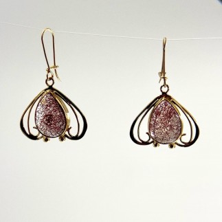 18k yellow gold earrings with red rutilated quartz set in 22k gold bezels. Medium weight. 1 1/2inches long including the ear wir