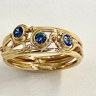 18k yellow gold hand built ring with three teal colored Montana sapphires .39ct (TW) (H)